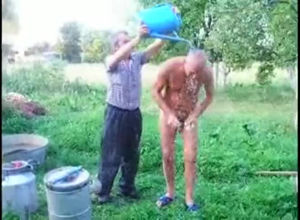 Mature daddy takes douche naked outdoor